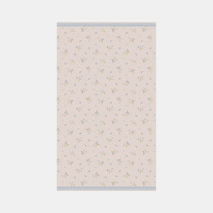 Floral patterned towel on a light pink background