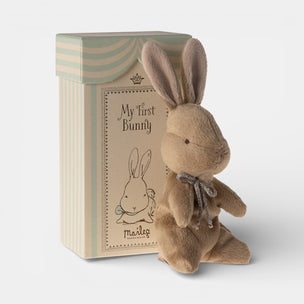 Stuffed bunny toy with packaging labeled 'My First Bunny' on a light background