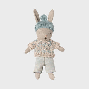 Maileg toy rabbit wearing a sweater and hat on a light gray background