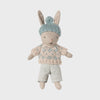 Maileg toy rabbit wearing a sweater and hat on a light gray background