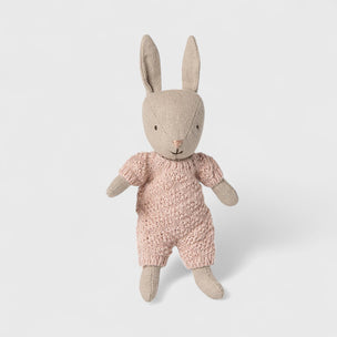 Maileg rabbit toy wearing a pink outfit on a white background