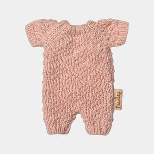 Pink knitted Maileg bunny romper with a brand tag on a light gray background