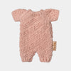 Pink knitted Maileg bunny romper with a brand tag on a light gray background