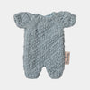 Knitted maileg bunny romper with a label on a light gray background