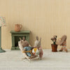 Maileg Miniature scene with stuffed animals in a room setting, including a lamp, fireplace, and decorative items.