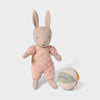 Maileg rabbit toy in a pink outfit with a ball on a light background