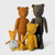 Maileg Four teddy bears of different sizes and colors on a white background