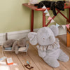 Maileg Gray elephant plush toy on a wooden floor with a child's play area in the background.