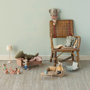 Maileg toys and furniture set on a carpeted floor against a light green wall.