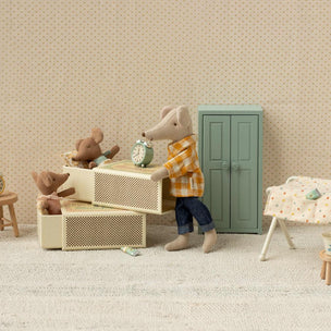 Maileg Miniature scene with a mouse character in a room with furniture and toys.
