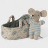 Maileg baby mouse  toy in a striped sweater next to a floral-patterned basket on a white background