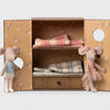 Maileg Two plush toy mice in front of a decorative box with plaid fabric inside.