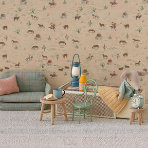 Maileg room with patterned wallpaper, sofa, and toys.