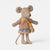 A small plush maileg mouse doll with beige fabric body and ears, wearing a peach and orange striped top, a plaid skirt, and carrying a yellow crossbody bag, photographed on a clean light gray background.
