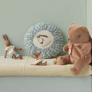 Maileg toys including a teddy bear and rabbit on a shelf against a light green wall.