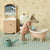 Toy mouse in a bathtub with bathroom furniture and decor in the background