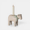 Wooden sheep-shaped candle holder with a candle on a white background