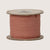 Spool of pink maileg ribbon on a beige background