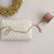 Gift wrapped in floral paper with pink ribbon on a light background