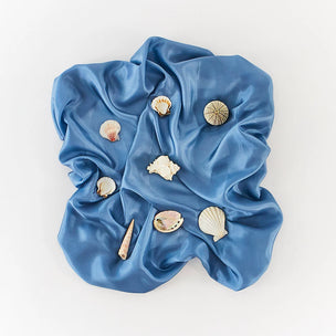Sarah's Blue silk fabric with seashells on a white background