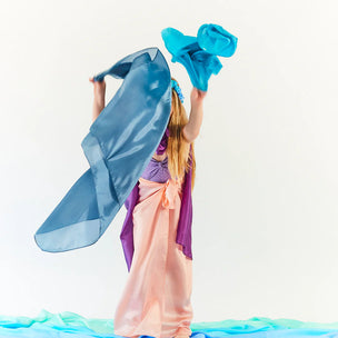 Person in a colorful costume with blue and pink elements on a white background