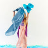 Person in a colorful costume with blue and pink elements on a white background