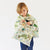 Child wearing a Winnie the Pooh-themed scarf on a white background