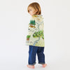 Child wrapped in a map-themed blanket on a white background