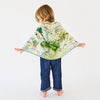 Child wearing a map-themed cape on a white background