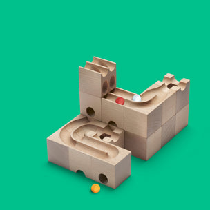 Cuboro wooden DUO Extra Set marble run shown with green background and 3 coloured marbles   | Conscious Craft