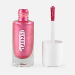 A bottle of metallic pink body gel with the cap off, showing the applicator wand loaded with the same shimmering pink polish, on a light gray background. The brand name 'namaki' is printed vertically on the bottle.