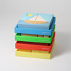 Grimm's Stack of colorful wooden blocks with a sailboat design on a light gray background