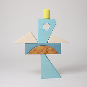 Grimm's Colorful geometric wooden block sculpture on a light gray background