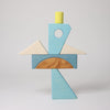 Grimm's Colorful geometric wooden block sculpture on a light gray background
