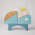 Grimm's Wooden toy sailboat with geometric shapes on a light gray background