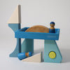 Set of colorful wooden toys with geometric shapes on a light gray background