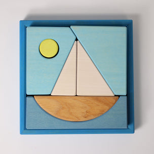 Grimm's Wooden puzzle with geometric shapes in a blue box on a light gray background