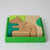 Grimm's Wooden puzzle of a squirrel in a green box on a white background