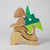 Grimm's Wooden and green puzzle piece on a light gray background