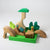Grimm's Wooden toy set with green and brown pieces on a white background