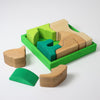 Wooden puzzle with green and brown pieces on a white background