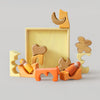 Grimm's Set of wooden toys with geometric shapes on a light gray background