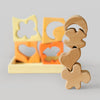 Grimm's Wooden shape sorter with various cut-out shapes on a gray background