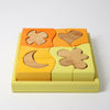 Grimm's Wooden shape puzzle with colorful blocks on a white background