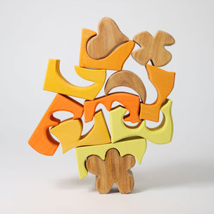 Grimm's Colorful wooden puzzle on a light gray background