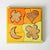 Grimm's Wooden shape puzzle with four pieces in a box on a white background