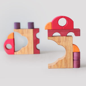Grimm's Colorful wooden building blocks on a light gray background