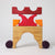 Grimm's Wooden toy structure with red, orange, and purple blocks on a white background