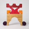 Grimm's Wooden toy structure with red, orange, and purple blocks on a white background