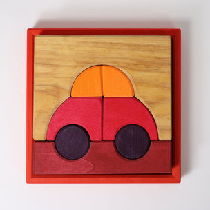 Grimm's Wooden car puzzle with red body, orange roof, and purple wheels in a red frame on a white background